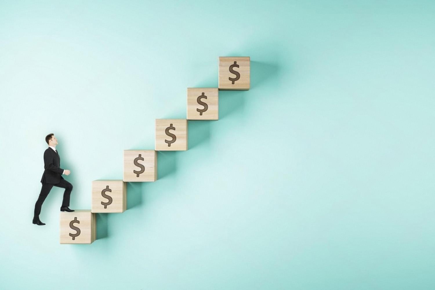 Businessman climbing wooden blocks marked with dollar signs, symbolising career and salary growth through additional education